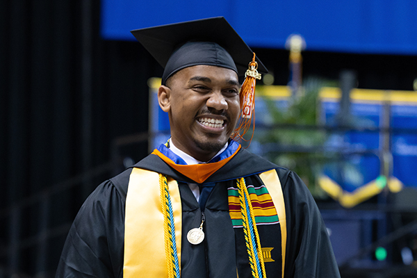 African American male graduate student smiling
