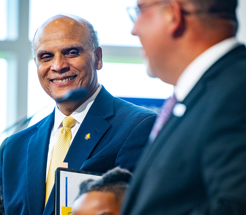 Chancellor Martin gesturing at commencemnt