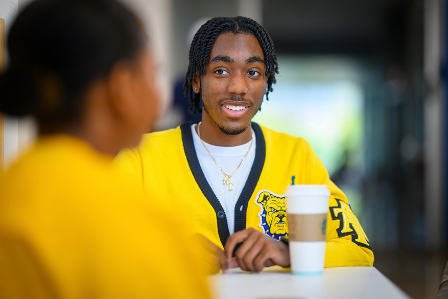 male student yellow cardigan