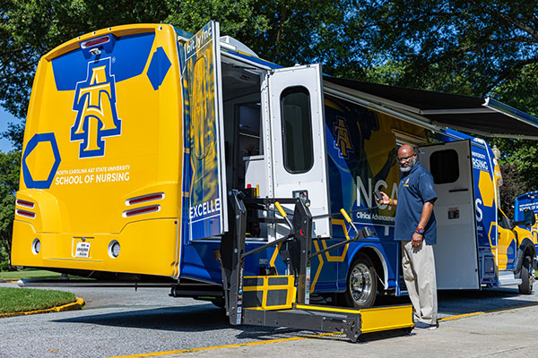 CIHDER Executive Director Angelo Moore demonstrates accessibility in one of the mobile nursing units