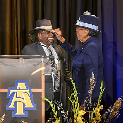 Congresswoman Alma Adams of North Carolina shares a joke with Alston Thompson, Ph.D., head of the Association of Research Directors/Ag Innovation, who wore a hat in her honor.