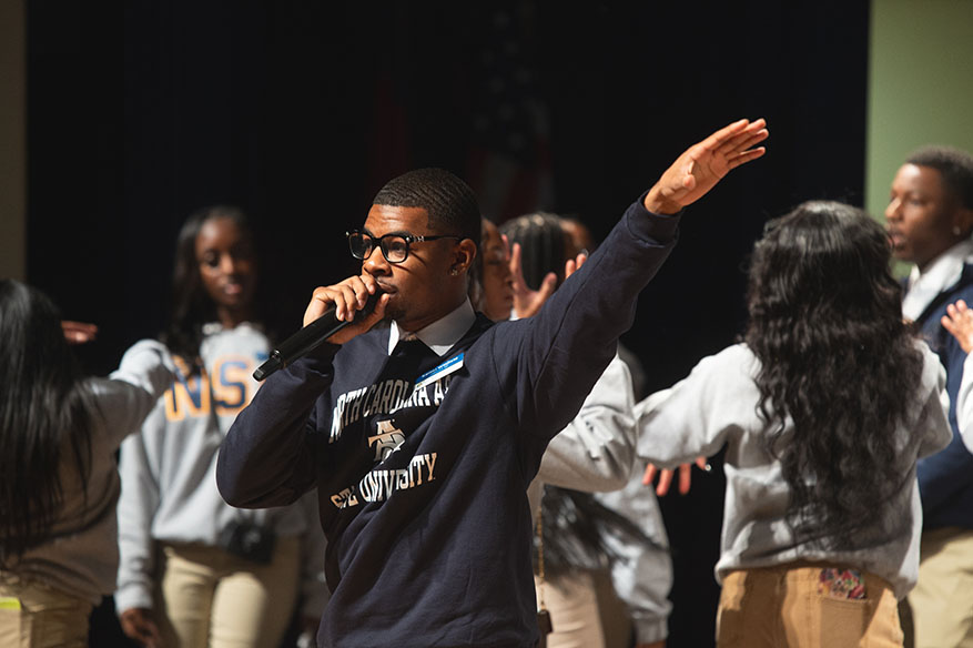 male student ambassador on stage